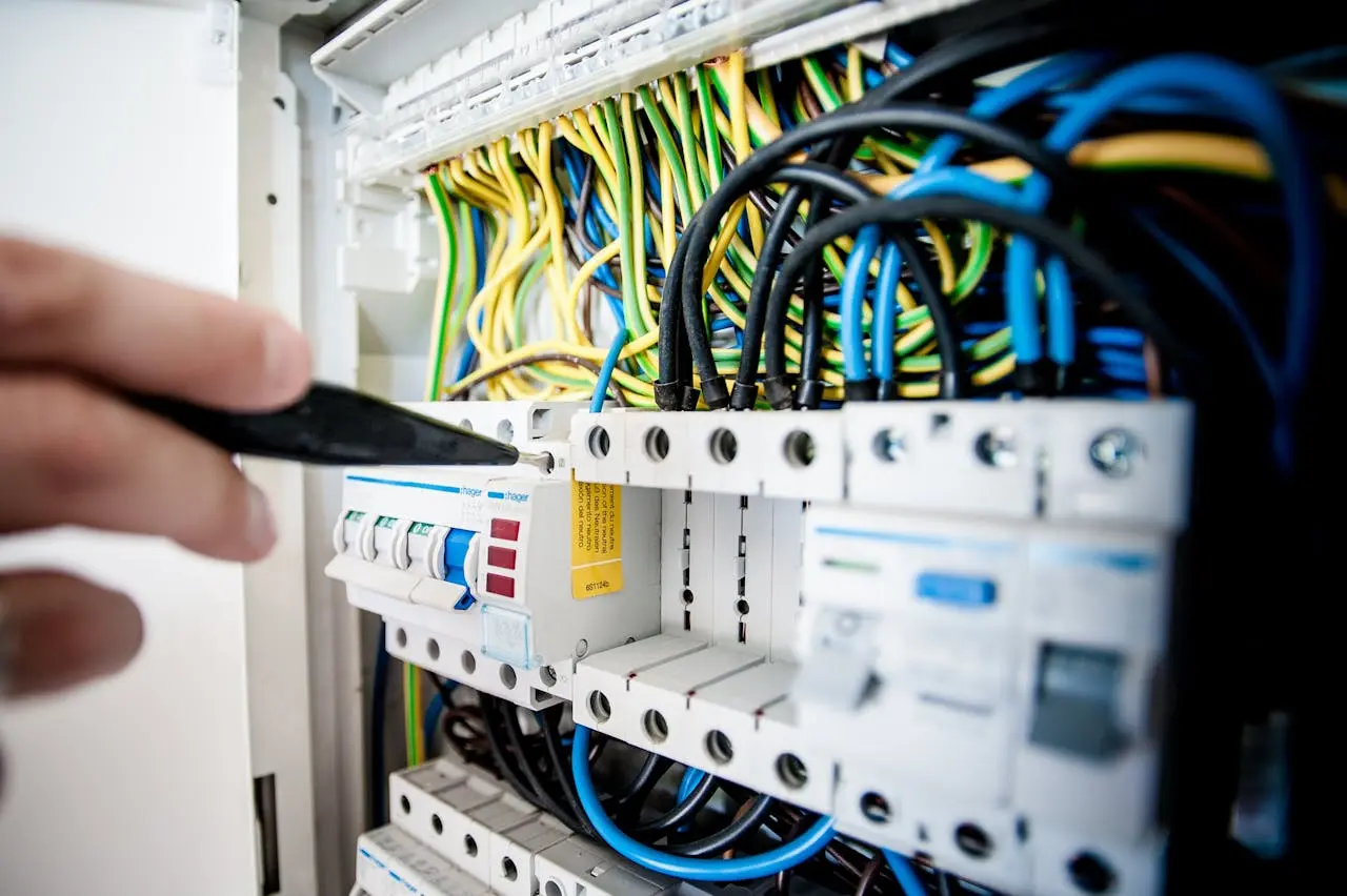 A hand testing an MCB